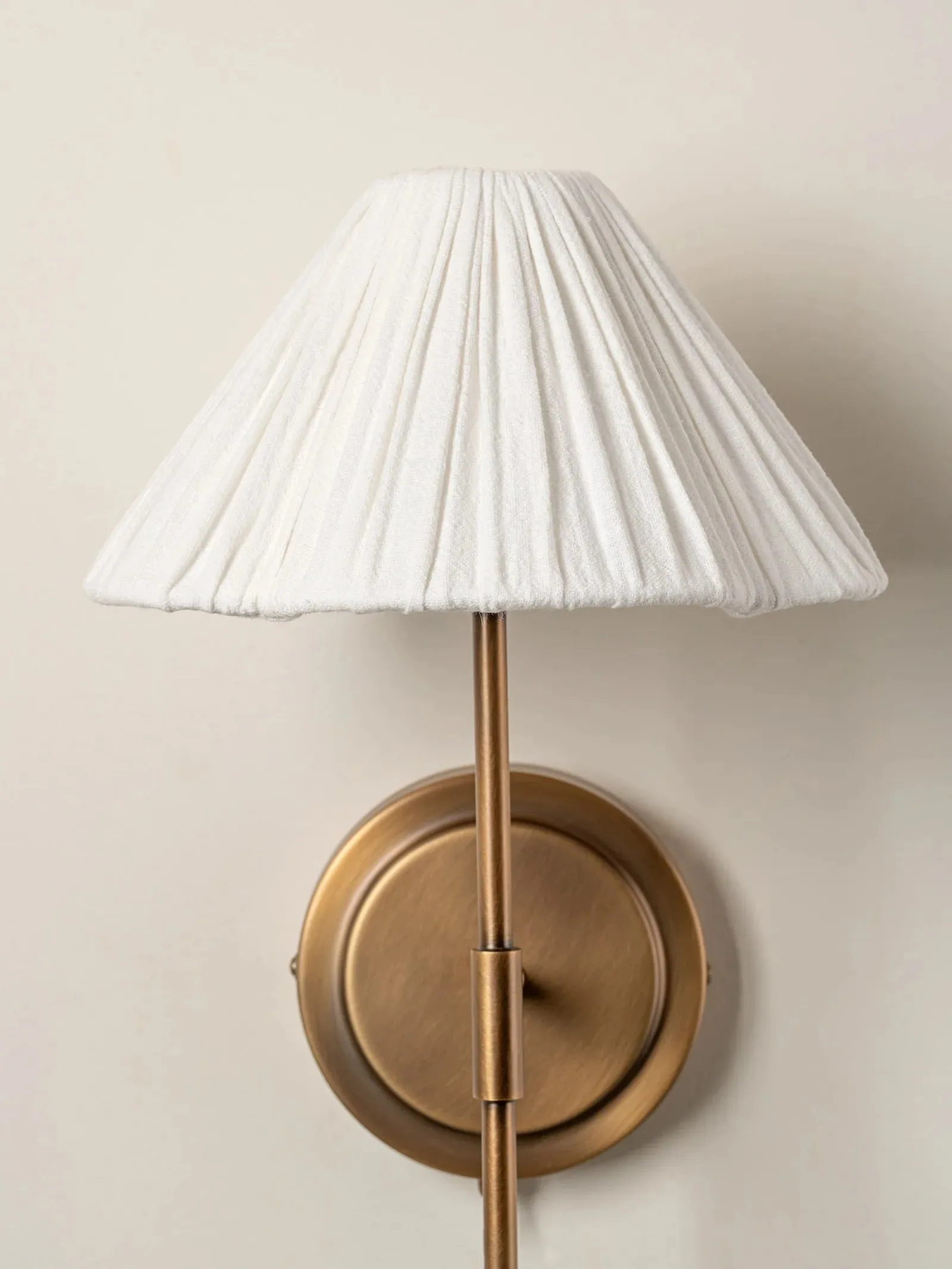 Lindi - aged brass and linen scalloped wall light